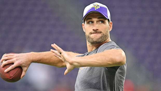 Kirk Cousins throws the football during warmups